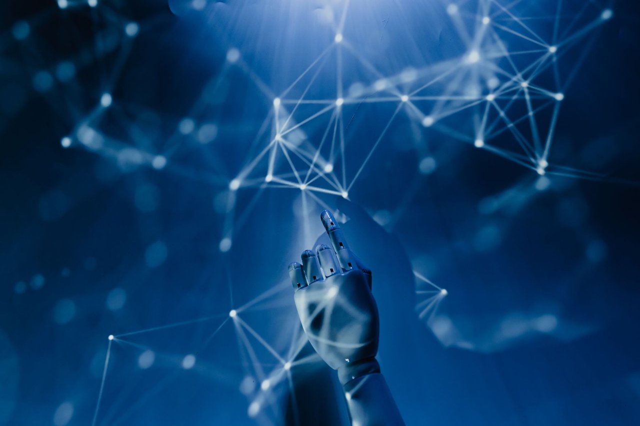 Mão robótica alcança uma rede digital azul, representando inteligência artificial e automação.
