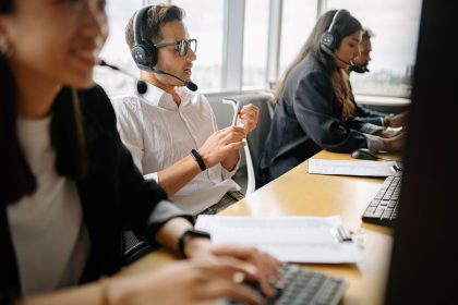 Equipe diversa de atendentes trabalha em um escritório moderno de serviços.